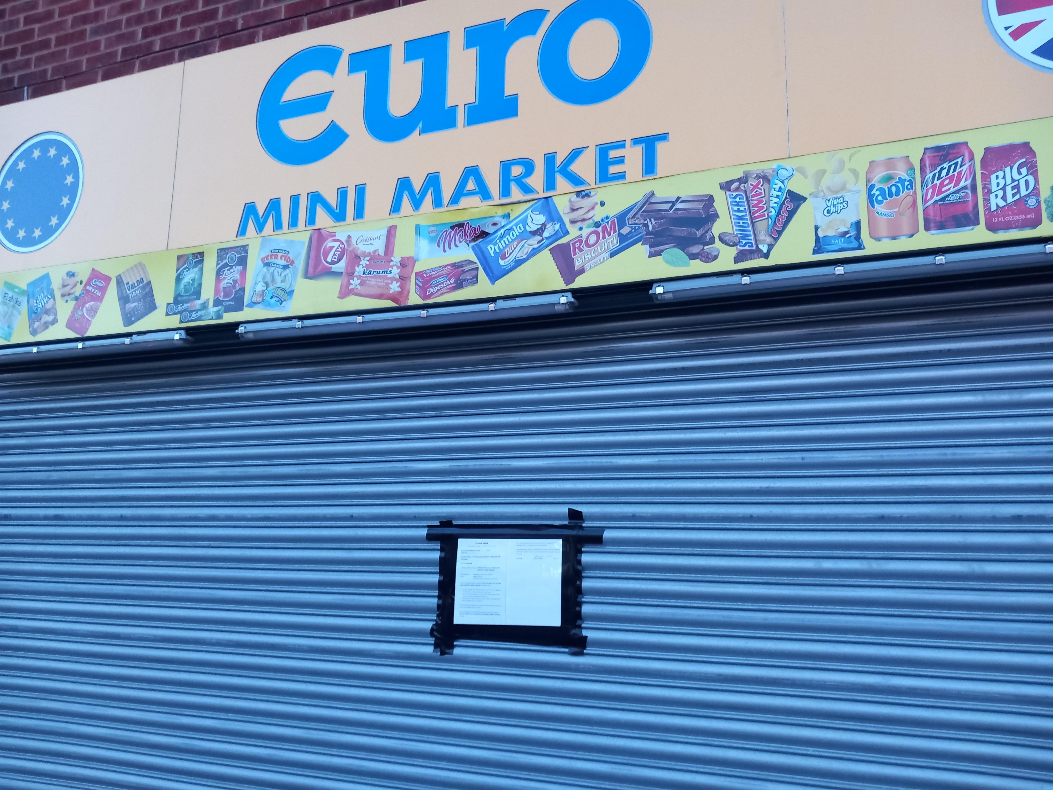 The outside of a shop with shutters down