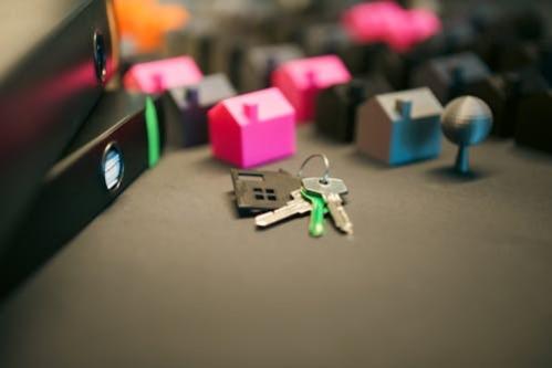 This shows a set of keys in front of a monopoly type houses