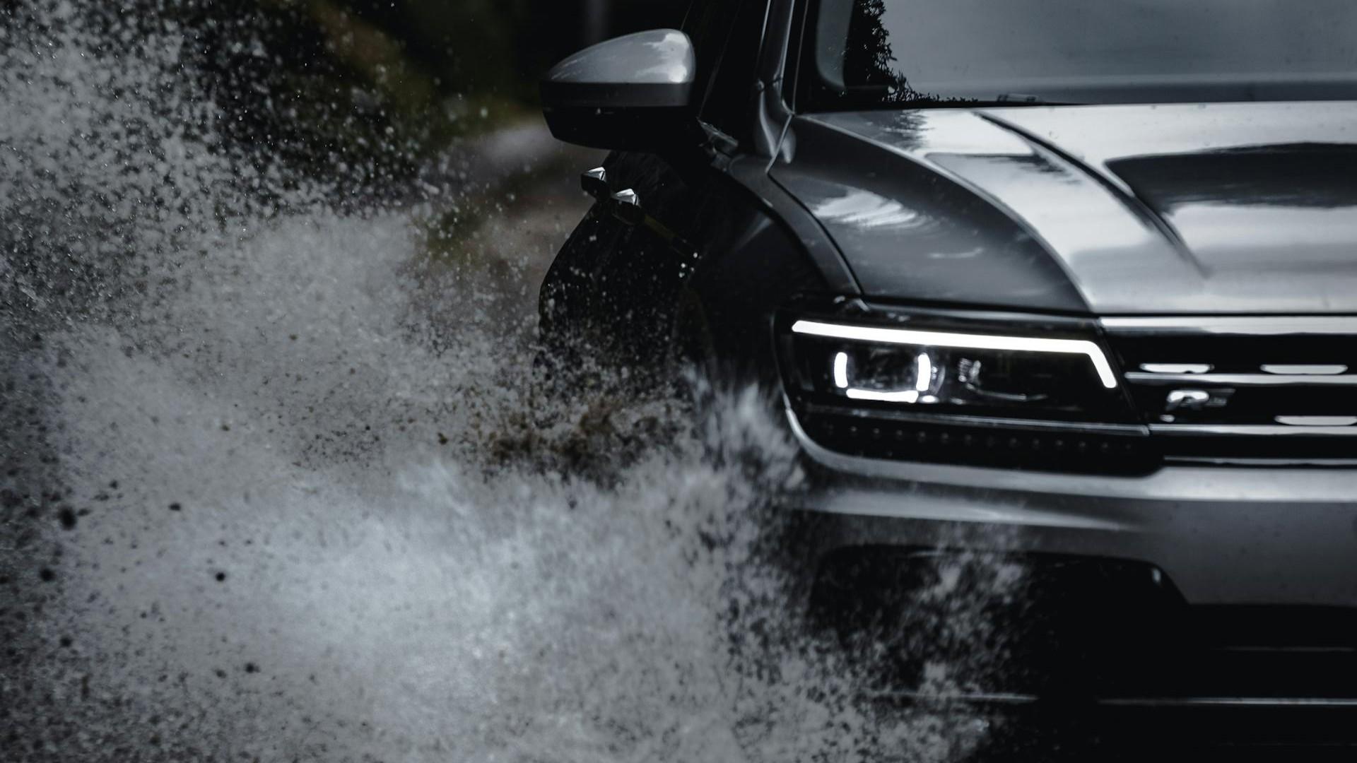 A car driving through a puddle