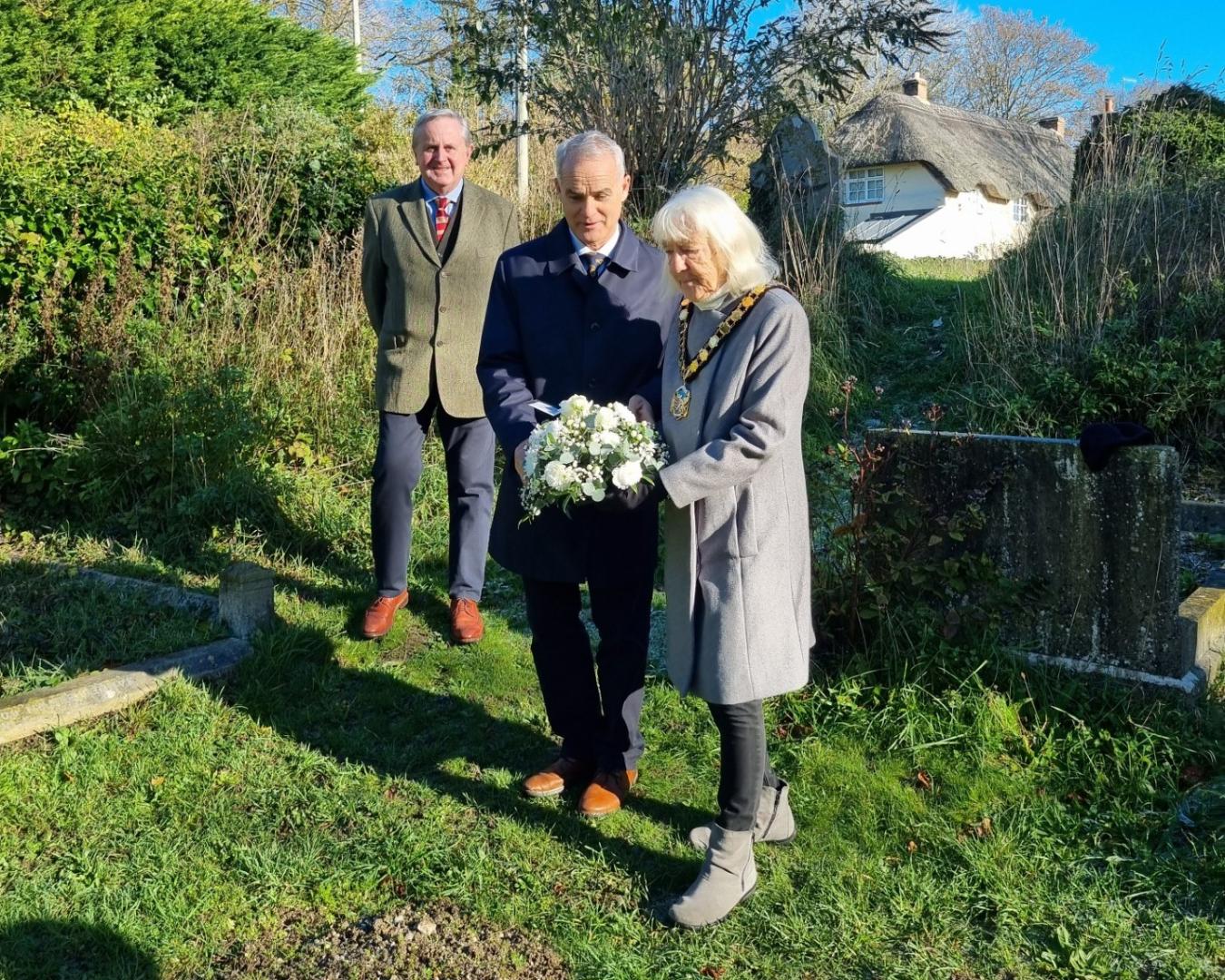 Cllr Stella Jones MBE, and the High Sheriff of Dorset, Mr Callum Bremner JP laying flowers at grave