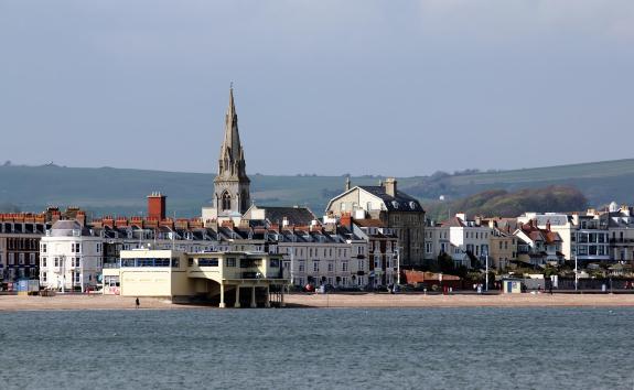 Weymouth Seafront showing hotels on Brunswick Terrace, the Pier Bandstand.